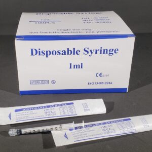 tube of disposable syringe next to a box