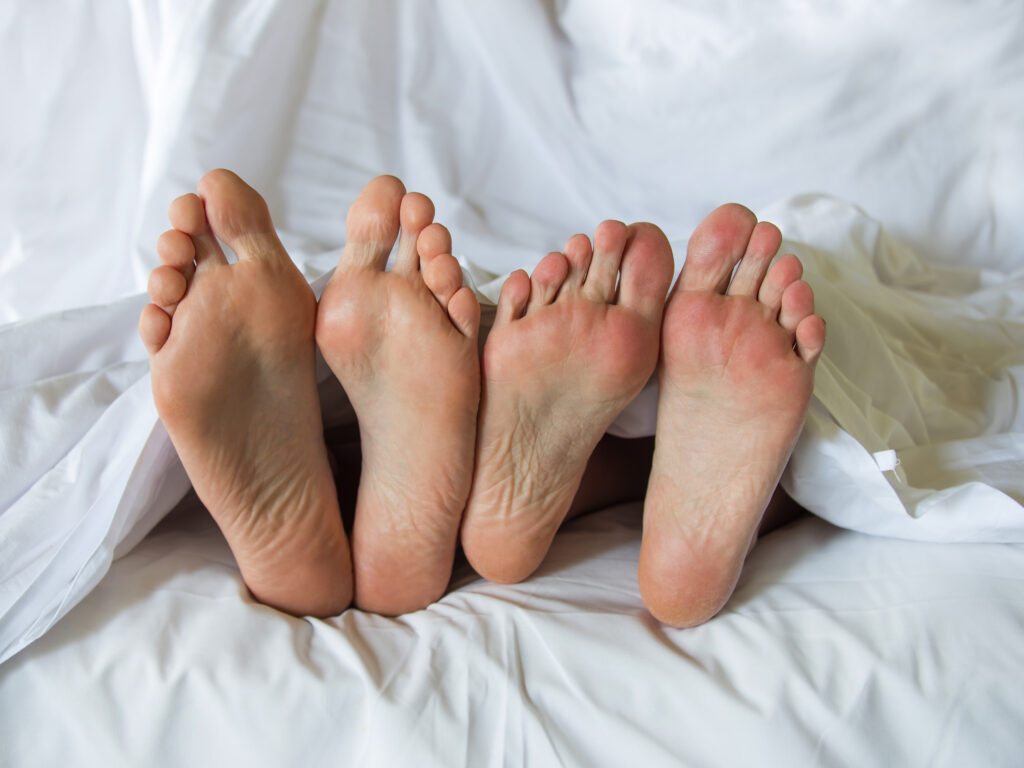 Man and woman under the sheets